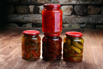 Jar with variety of pickled vegetables. Carrots, field garlic, parsley in glas. Preserved food. Fermented preserved vegetarian food concept. Canned food