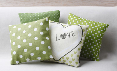 Spotted green cushions with love message