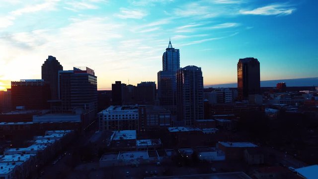Aerial, sunset over Raleigh skyline