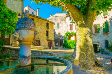 a narrow street in the old town of Vaison-la-Romaine in France