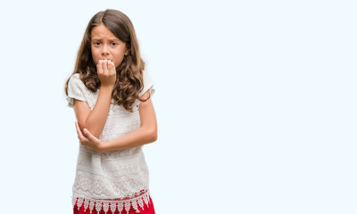 Brunette hispanic girl looking stressed and nervous with hands on mouth biting nails. Anxiety problem.