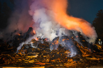 burning recyclable materials in the fire at night