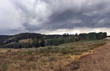 storm clouds roll by in northern utah mountain range near ogden and salt lake city