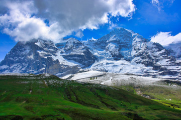 Fototapeta na wymiar mountains and fields and blue sky of the Switzerland