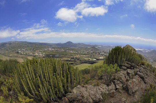 The panoramic views from the summit of Roque del Conde, towards the southern coast of the island, a table-top mountain, an arid landscape with scarce endemic flora, in Tenerife, Canary Islands, Spain