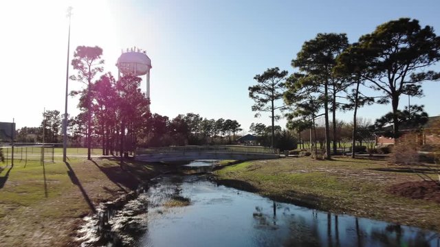 Low angle aerial, water tower over river in North Carolina