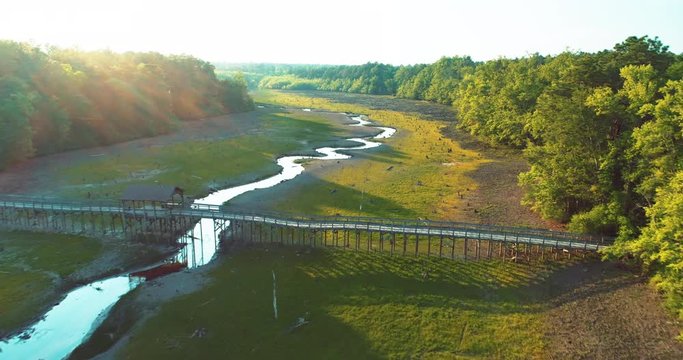Wide aerial, bridge over river landscape