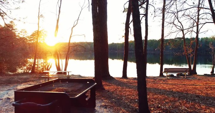 Sunset over park near lake, aerial