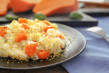 Plate with delicious pumpkin risotto on table, closeup
