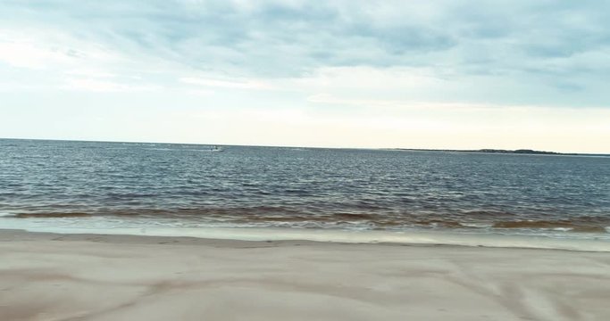 Waves lap on beach, aerial