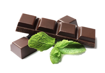 Pieces of dark chocolate with mint on white background