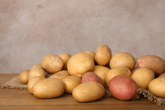 Pile of fresh organic potatoes on wooden table