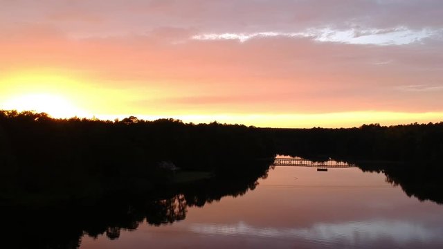 Aerial, scenic sunset over lake in Southern Pines