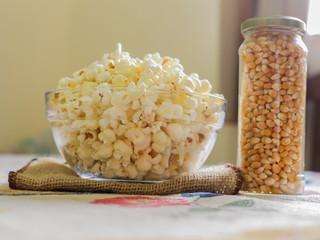 glass bowl with popcorn and corn seeds