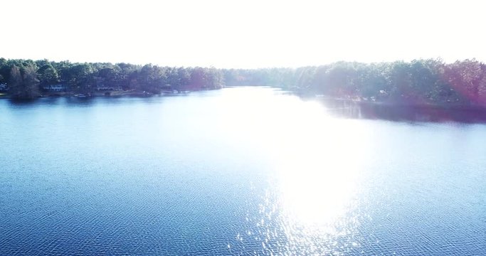 Aerial, shining lake in Whispering Pines
