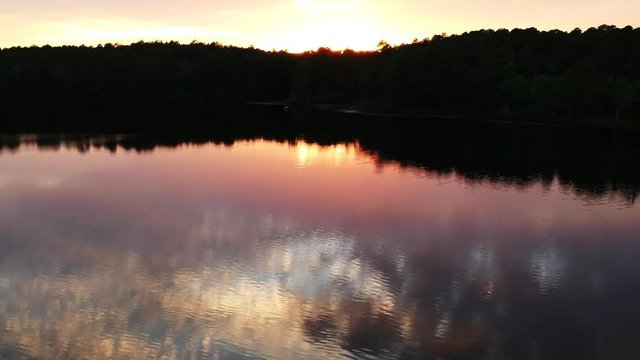 Tilt up aerial, sunset over lake