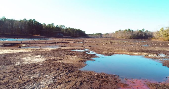 Panning aerial, dried riverbed in rural North Carolina