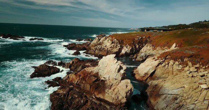 Panning aerial, rocky coast of California