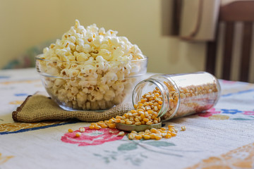 glass bowl with popcorn and corn seeds