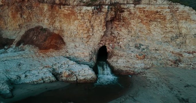 Aerial, water flows on California beach