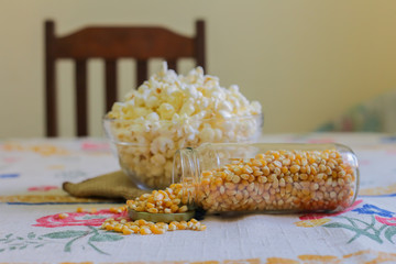 glass bowl with popcorn and corn seeds