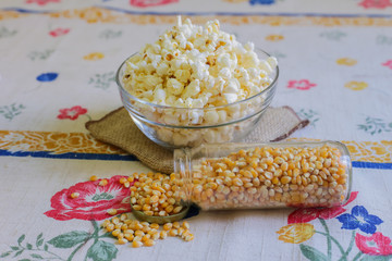 glass bowl with popcorn and corn seeds