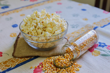 glass bowl with popcorn and corn seeds