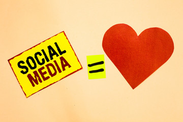 Handwriting text writing Social Media. Concept meaning Online communication channel Networking Microblogging Yellow piece paper reminder equal sign red heart sending romantic feelings