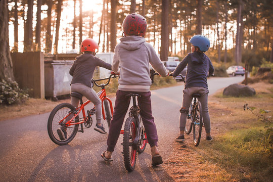 a group of boys on their bikes in the summer during sunset in a campground