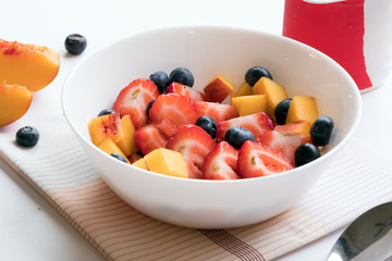 Bowl of healthy fresh berries fruit salad served on table