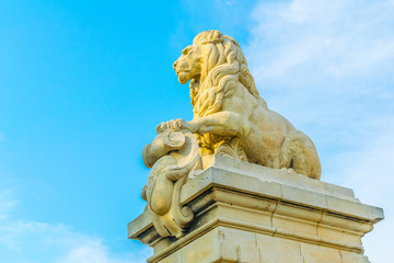 Lion statue on a riverside of Rhone commemorates a collapsed bridge in Arles, France
