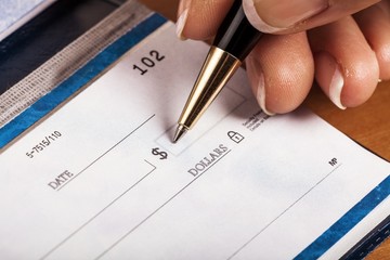 Woman's Hand Writing a Check - Close Up