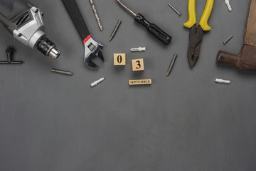 Table top view aerial image of decoration the sign of USA labor day on Sep 3,2018 background concept. Flat lay accessories US flag and essential tools worker on modern  grey wooden with copy space.