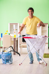 Leg injured man doing clothing ironing at home