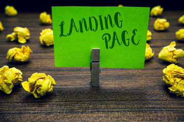 Naklejka premium Conceptual hand writing showing Landing Page. Business photo text Website accessed by clicking a link on another web page Clothespin holding green paper note crumpled papers mistakes