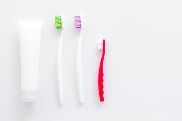Clean teeth. Toothbrushes and tooth paste on white background top view space for text