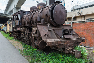 Fototapeta na wymiar Abandoned Ancient old steam locomotive