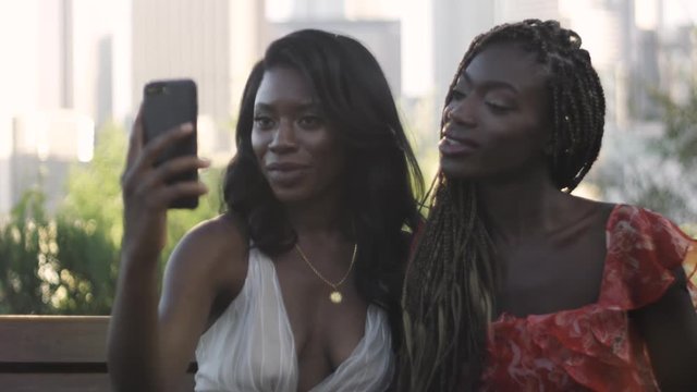 Slow Motion of two African American women taking selfies in Los Angeles