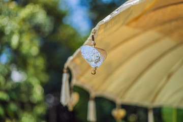 Traditional Balinese yellow sun umbrella with tassels