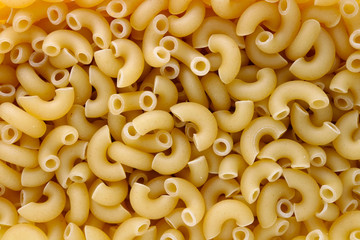 Dry small pasta in the form of short half round  tubes studio food macro