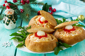 Festive appetizer on the Christmas table. Bun stuffed with shrimp salad and red caviar.