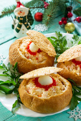 Festive appetizer on the Christmas table. Bun stuffed with shrimp salad and red кавиар close-up.