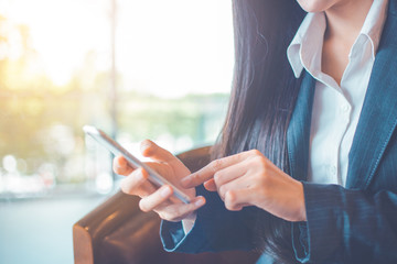 Business women hand are using cell phones in office.