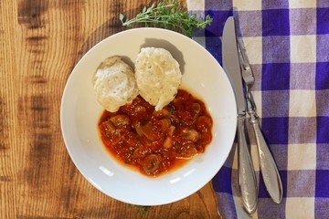 South Tyrolian cheese dumplings with tomato sauce on a white plate