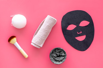Black facial mask. Black head remover mask. Mask with clay on pink background top view