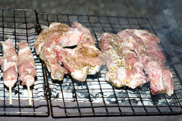 Raw steak greek on grill with oregano and salt
