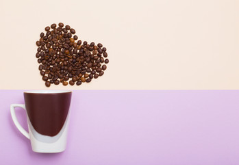 cup  with coffee beans in in the shape of a heart