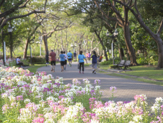 Fototapeta premium Flower with blurred running people