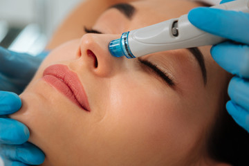 Modern cosmetology. Close up of a modern device for hydrafacial procedure used for face cleansing