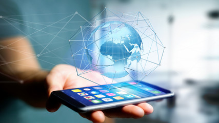 Businessman using smartphone with a Connected network over a earth globe concept on a futuristic interface - 3d rendering